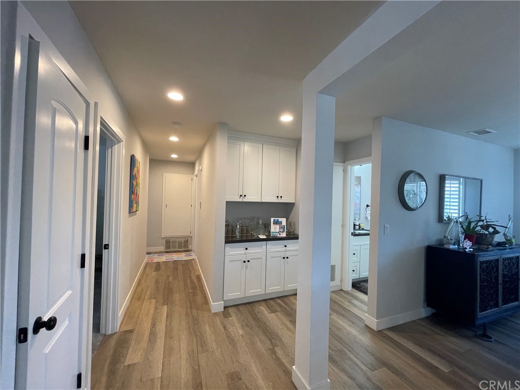 28950 Pebble Beach Drive Menifee, CA 92586 - Photo 10 of 18 a view of a hallway with wooden floor and windows
