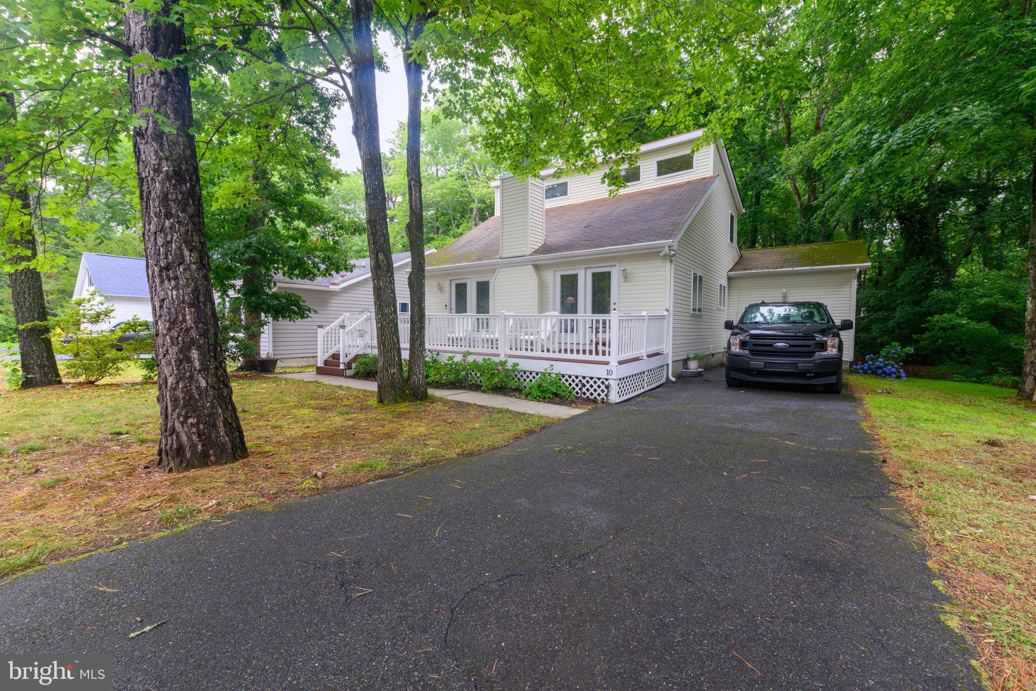 10 Gloucester Road Ocean Pines, MD 21811 - Photo 31 of 37 a car parked in front of a house with a yard