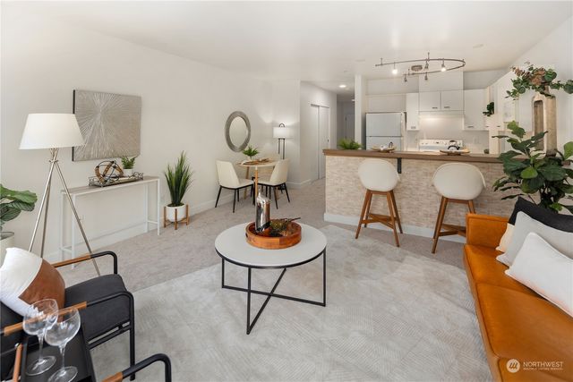 a living room with furniture and a lamp