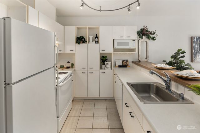 a kitchen with a sink and refrigerator