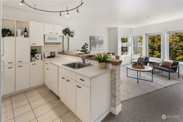 a kitchen with a sink cabinets and window