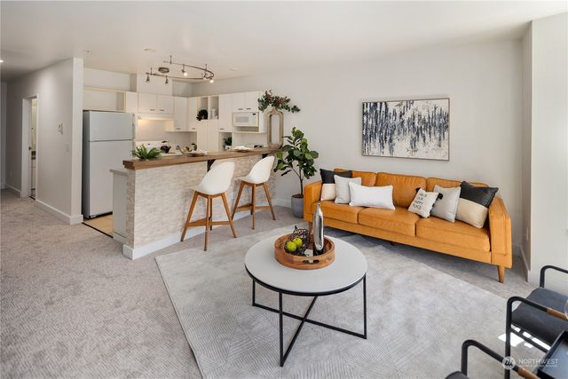 a living room with furniture kitchen and a table