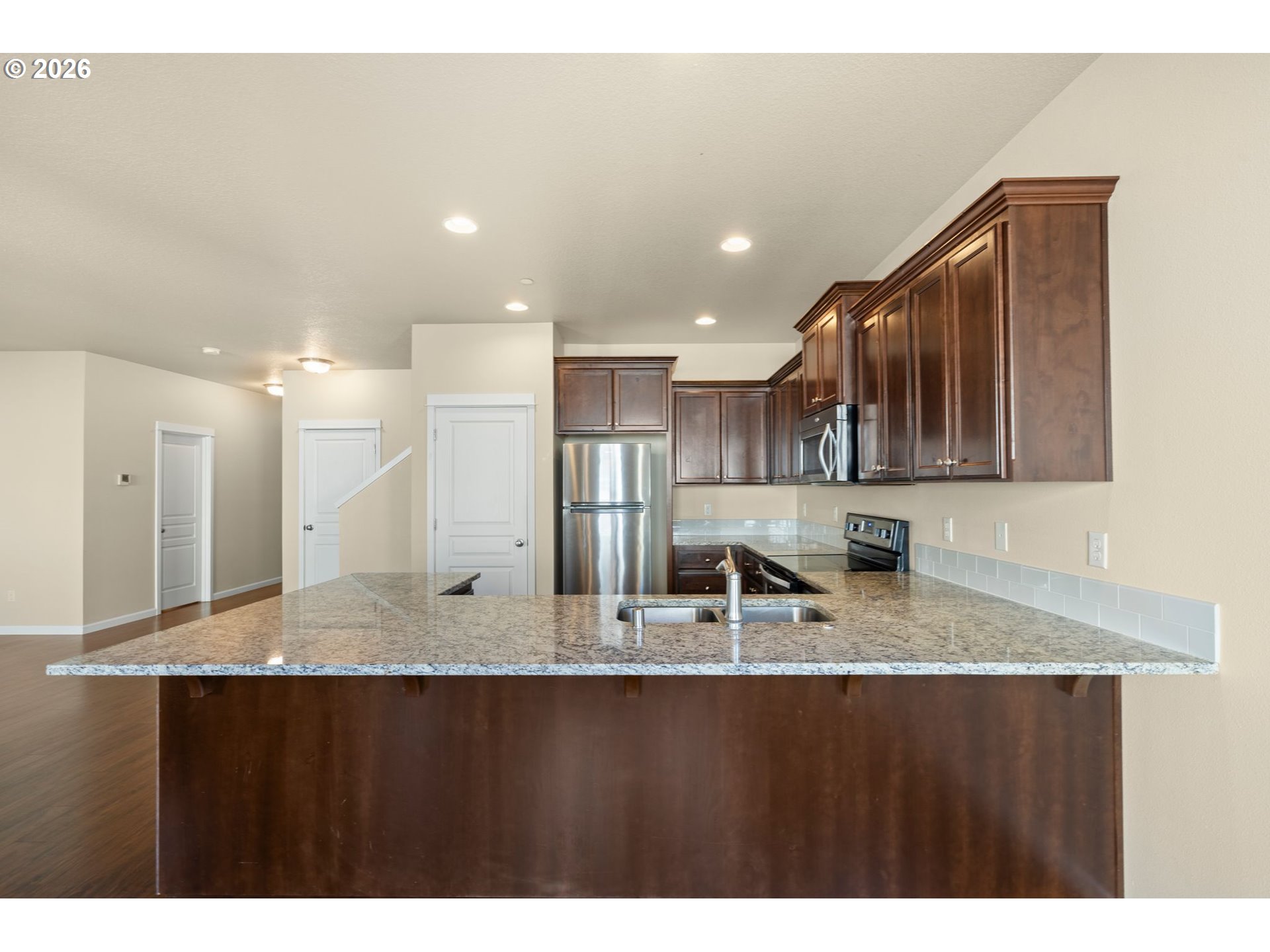 3010 Northeast 74th Street Vancouver, WA 98665 - Photo 14 of 39 a kitchen with stainless steel appliances granite countertop a sink a stove and a refrigerator