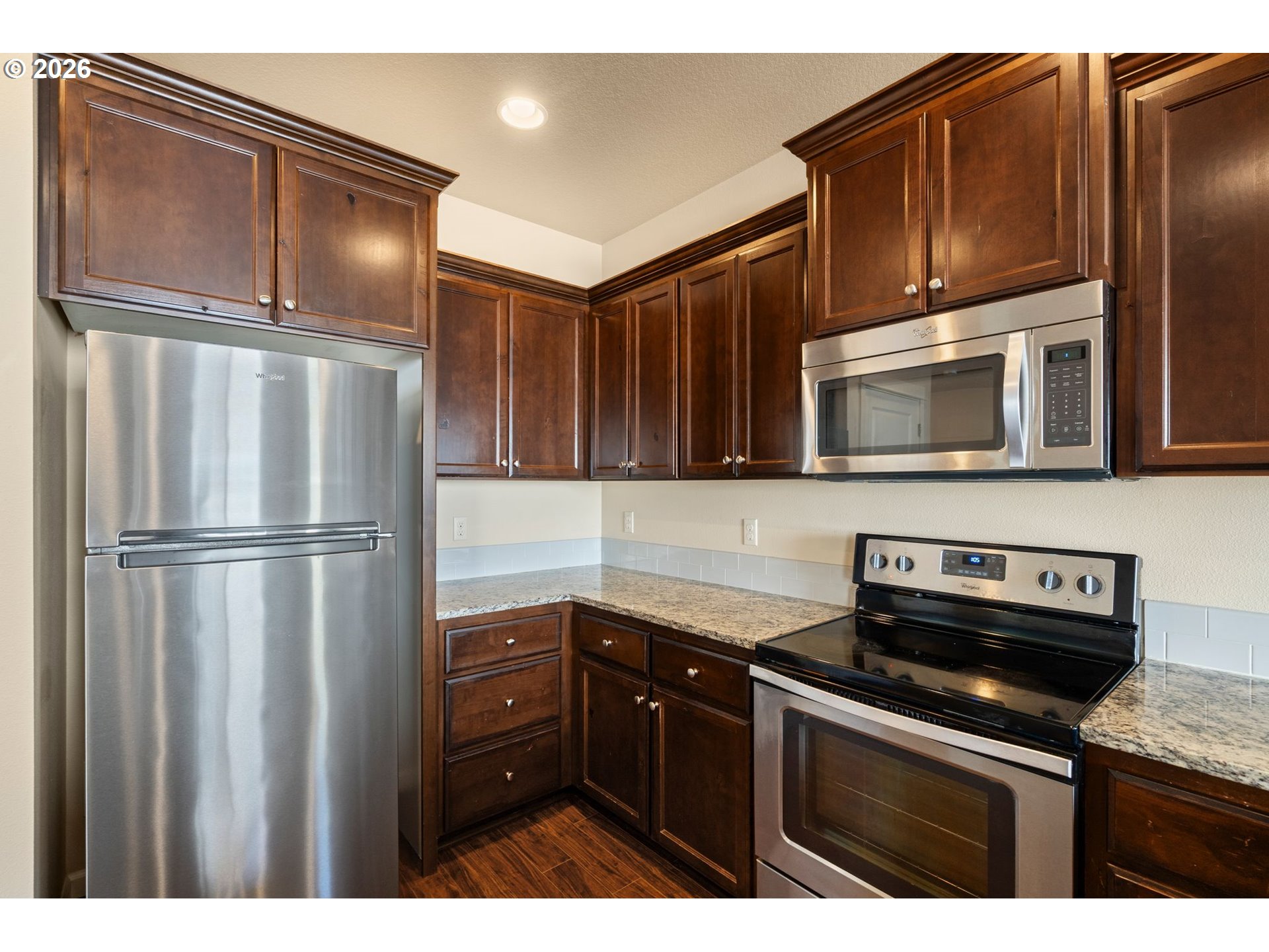 3010 Northeast 74th Street Vancouver, WA 98665 - Photo 15 of 39 a kitchen with granite countertop stainless steel appliances and wooden cabinets