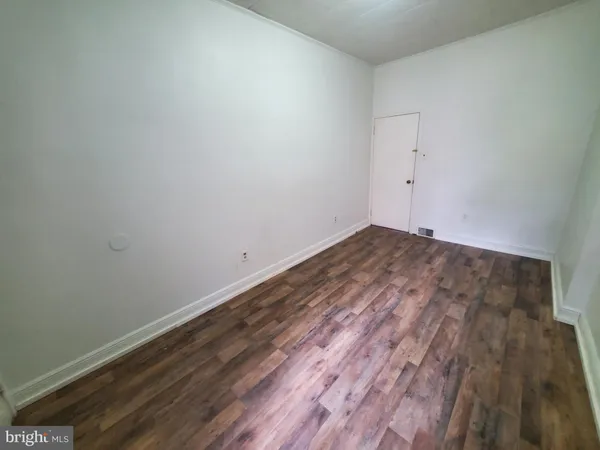 a view of room with wooden floor