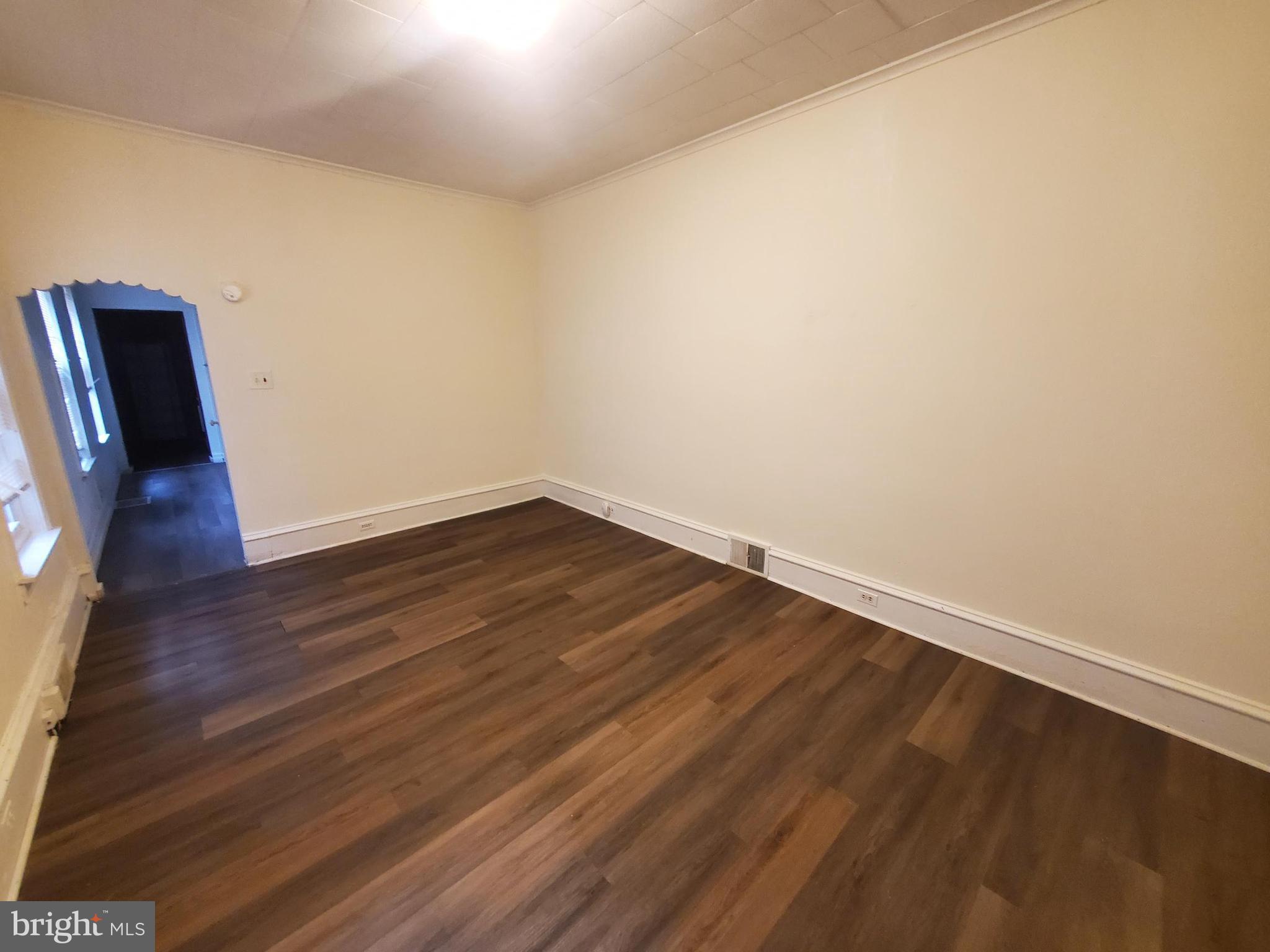 645 North 3rd Street, Unit 1 Reading, PA 19601 - Photo 5 of 9 a view of an empty room with wooden floor