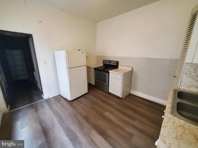 a view of kitchen and wooden floor