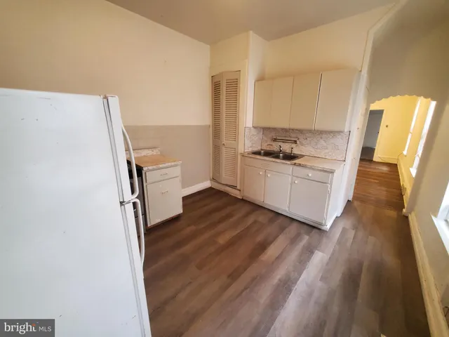 a kitchen with a sink stove and refrigerator