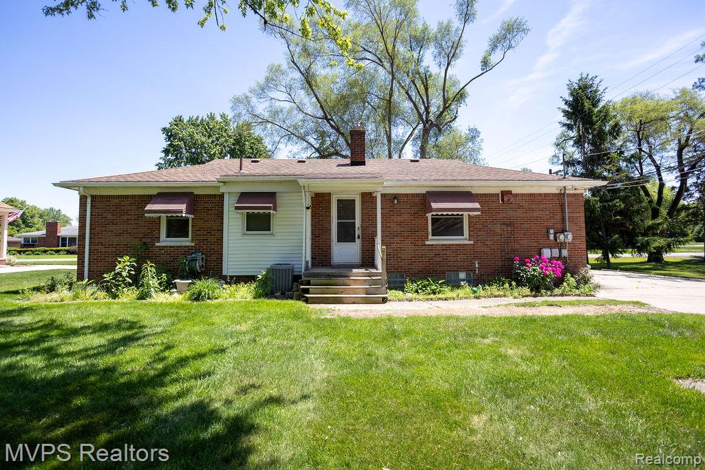 33033 Edgegrove Road Fraser, MI 48026 - Photo 6 of 20 Brick exterior with white siding accents and a shingle roof