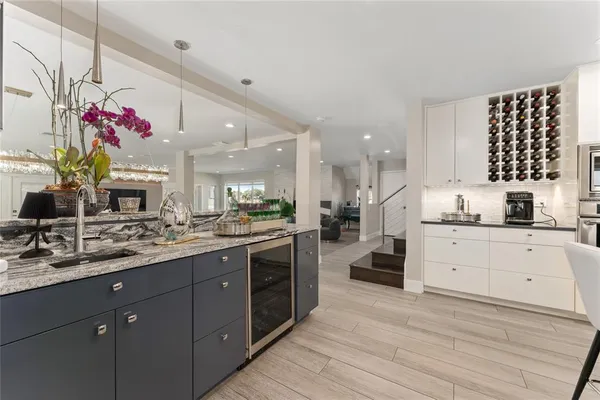 a kitchen with stainless steel appliances granite countertop a kitchen island a stove a table and chairs in it