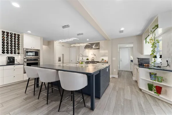 a large kitchen with stainless steel appliances lots of counter top space