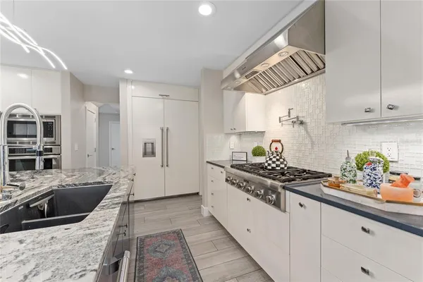 a bathroom with a granite countertop toilet sink and mirror