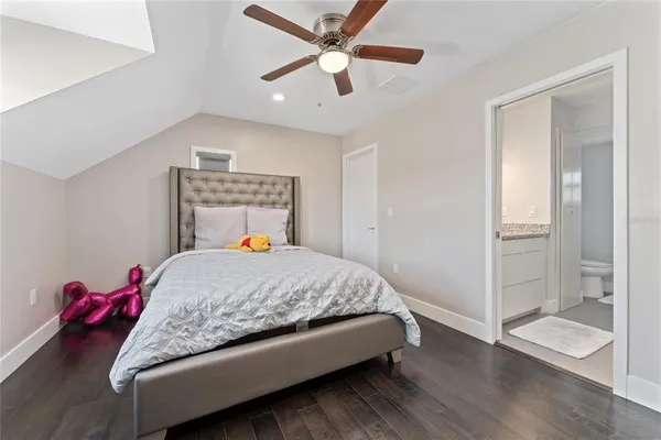 a bedroom with a bed and a painting on the wall