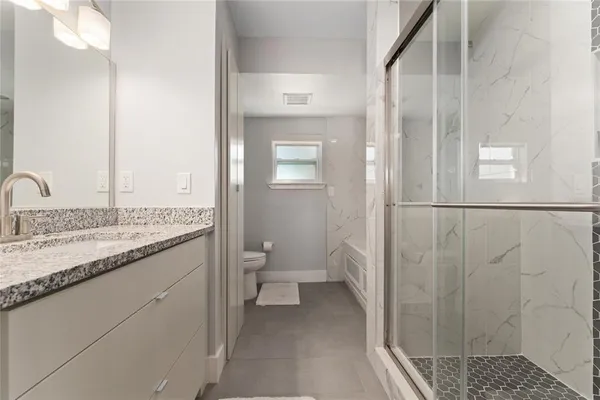 a spacious bedroom with a bed and a flat screen tv