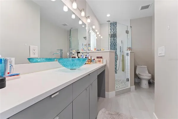 a bathroom with a tub a sink and a mirror