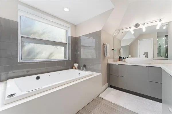 a bedroom with a bed and a ceiling fan