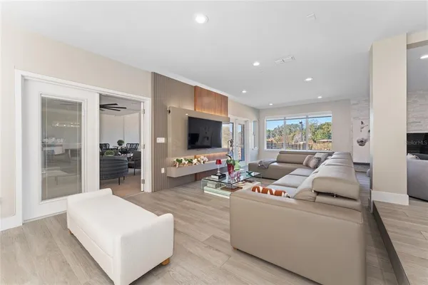 a kitchen with a dining table chairs and wooden floor