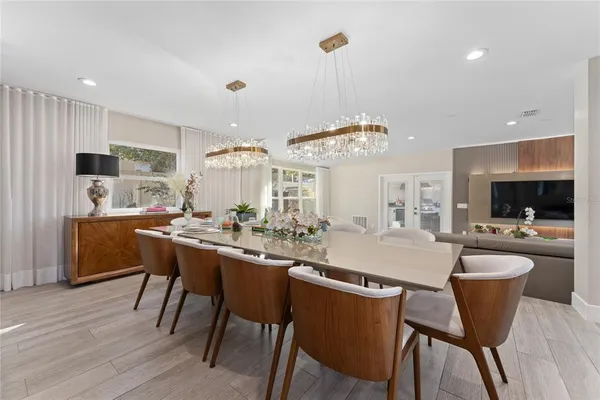 a large kitchen with a lot of counter space and wooden floor