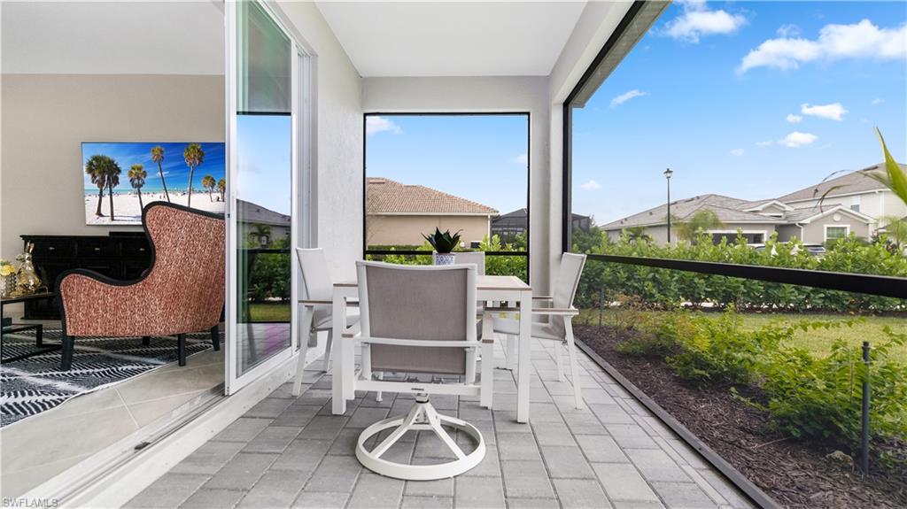 2425 Orchard Street Naples, FL 34120 - Photo 10 of 28 a living room with furniture and a floor to ceiling window