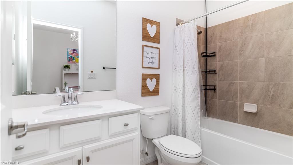 2425 Orchard Street Naples, FL 34120 - Photo 17 of 28 a bathroom with a sink toilet and shower