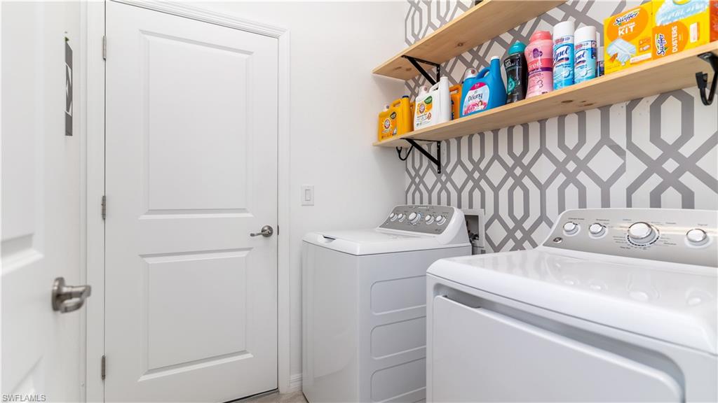 2425 Orchard Street Naples, FL 34120 - Photo 19 of 28 a bathroom with a sink and a shower curtain