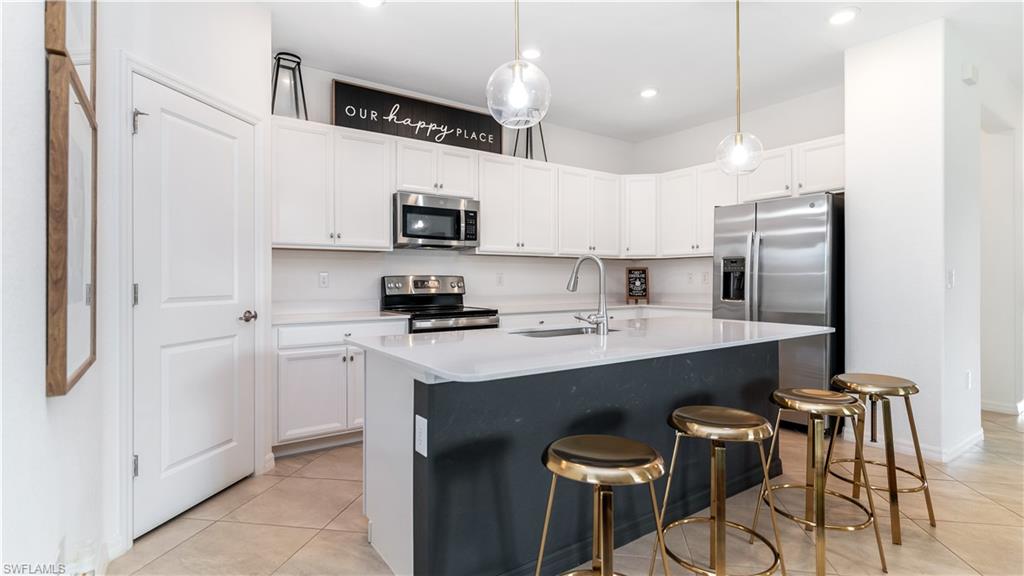 2425 Orchard Street Naples, FL 34120 - Photo 2 of 28 a kitchen with stainless steel appliances a sink a stove a refrigerator and cabinets