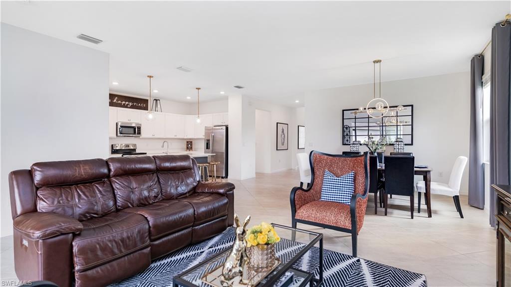 2425 Orchard Street Naples, FL 34120 - Photo 22 of 28 a living room with furniture a dining table and chairs