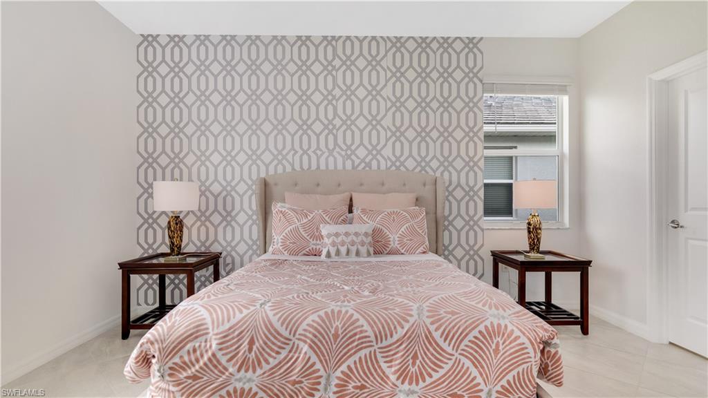 2425 Orchard Street Naples, FL 34120 - Photo 24 of 28 a bedroom with a bed and a lamp on table