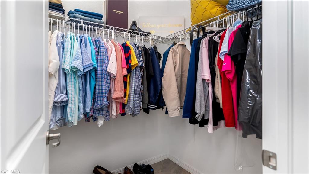 2425 Orchard Street Naples, FL 34120 - Photo 25 of 28 a view of walk in closet with clothes