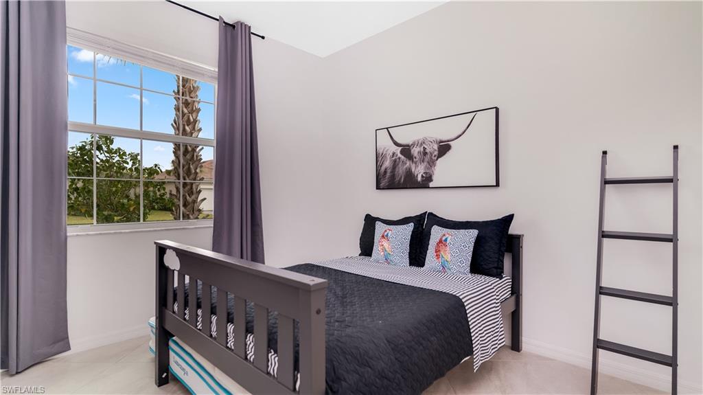2425 Orchard Street Naples, FL 34120 - Photo 26 of 28 a bedroom with a bed and a painting on the wall