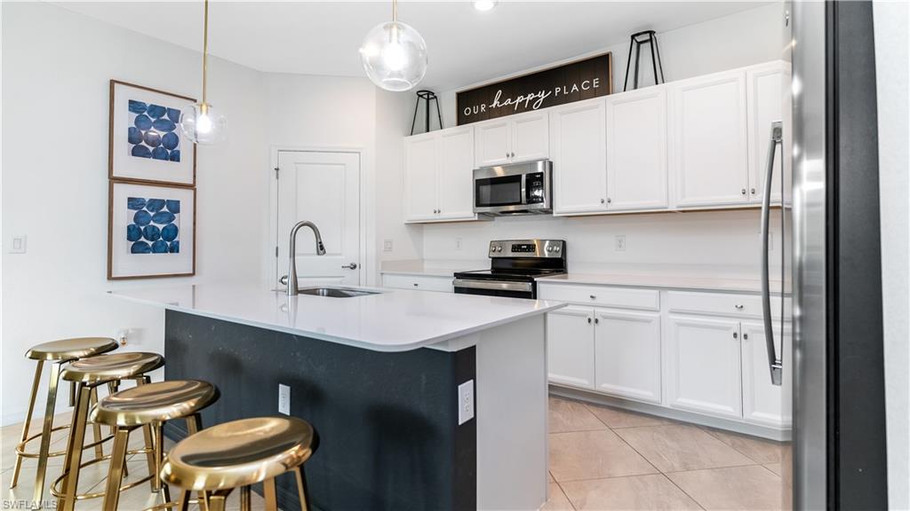 2425 Orchard Street Naples, FL 34120 - Photo 3 of 28 a kitchen with a sink cabinets and wooden floor