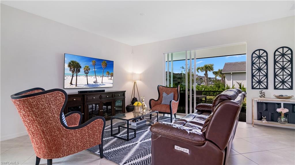 2425 Orchard Street Naples, FL 34120 - Photo 6 of 28 a living room with furniture a rug and a large window