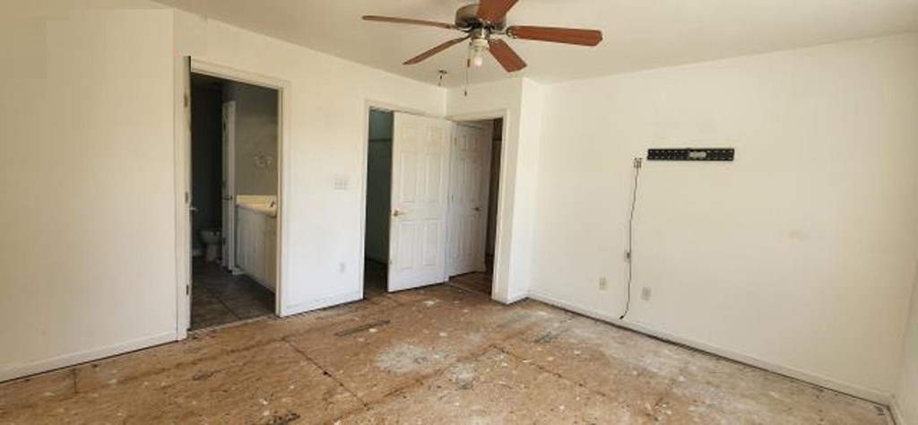 2402 Octopus Road Greenbackville, VA 23356 - Photo 10 of 21 an empty room with closet and a chandelier fan