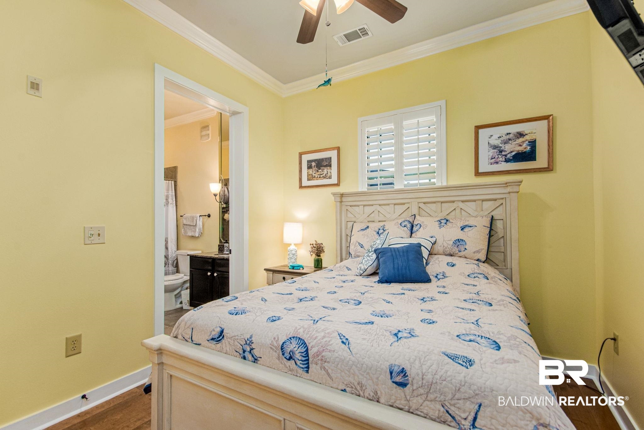 1430 Regency Road, Unit I201 Gulf Shores, AL 36542 - Photo 11 of 34 Bedroom featuring ensuite bath, dark wood-type flooring, crown molding, and ceiling fan