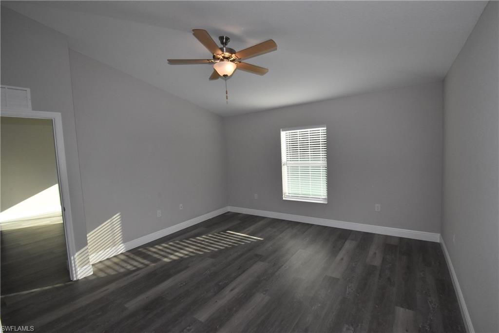 202 Seagrape Street Port Charlotte, FL 33954 - Photo 13 of 21 a view of an empty room with wooden floor and a window