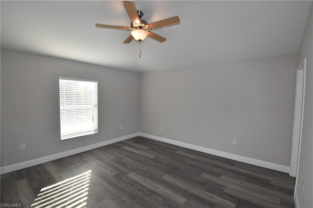 202 Seagrape Street Port Charlotte, FL 33954 - Photo 16 of 21 wooden floor in an empty room with a window
