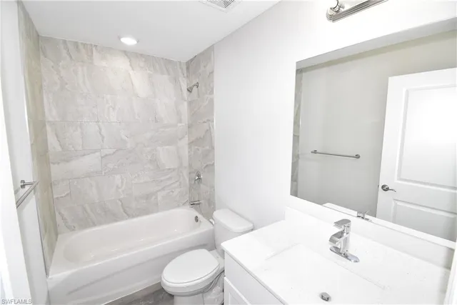 a bathroom with a sink a toilet and a bathtub