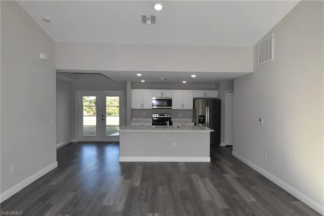 a view of kitchen and hall with wooden floor