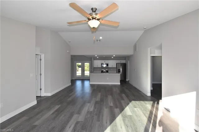a view of a livingroom with a window and wooden floor
