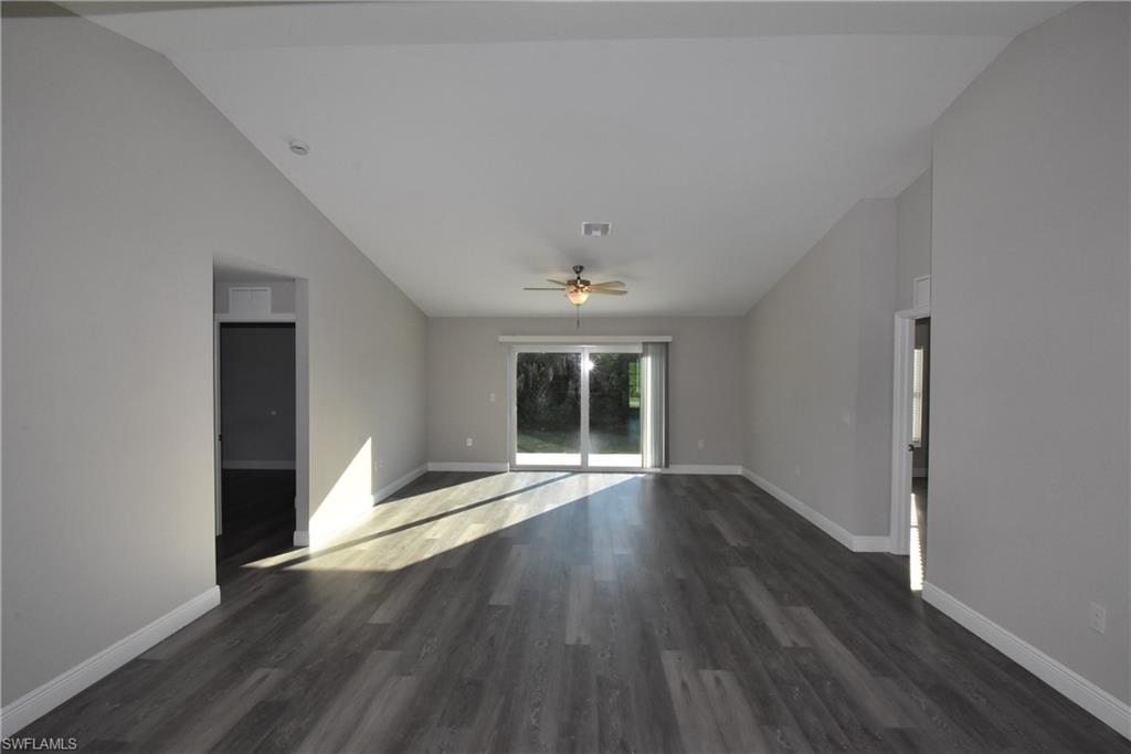 202 Seagrape Street Port Charlotte, FL 33954 - Photo 7 of 21 an empty room with wooden floor and windows