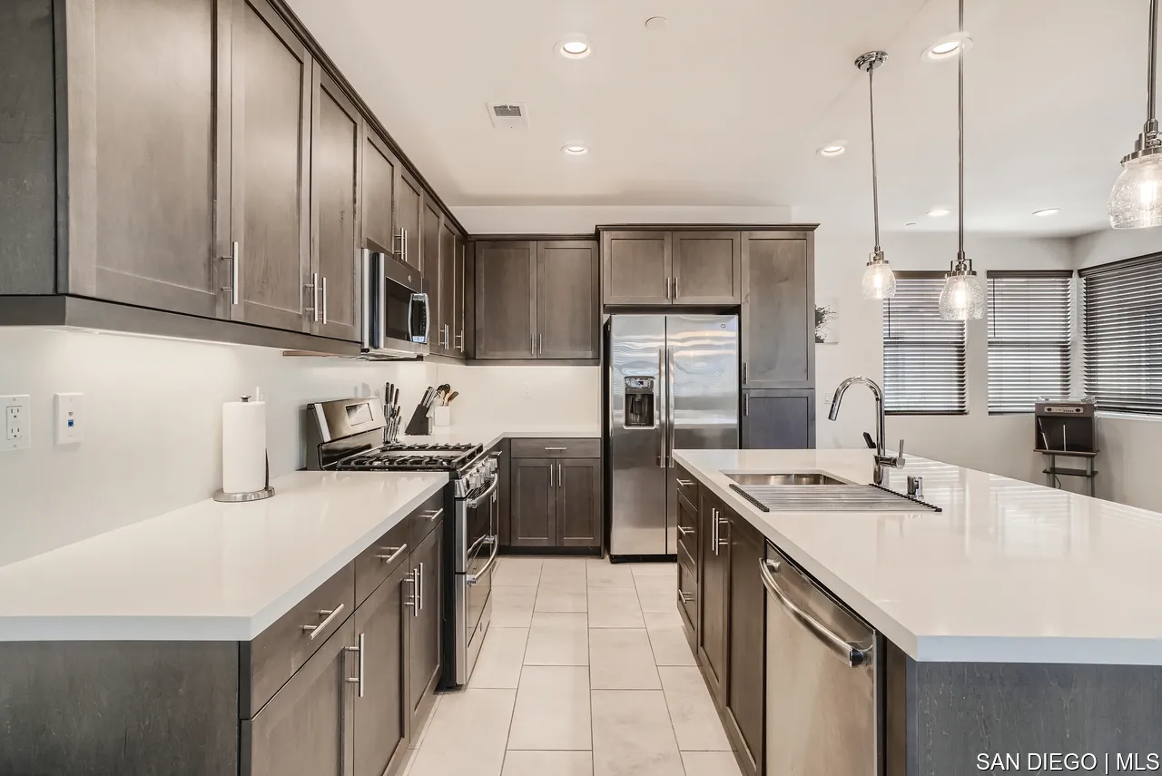 2110 Element Way Chula Vista, CA 91915 - Photo 11 of 33 a kitchen with stainless steel appliances a sink a stove a refrigerator a center island and cabinets