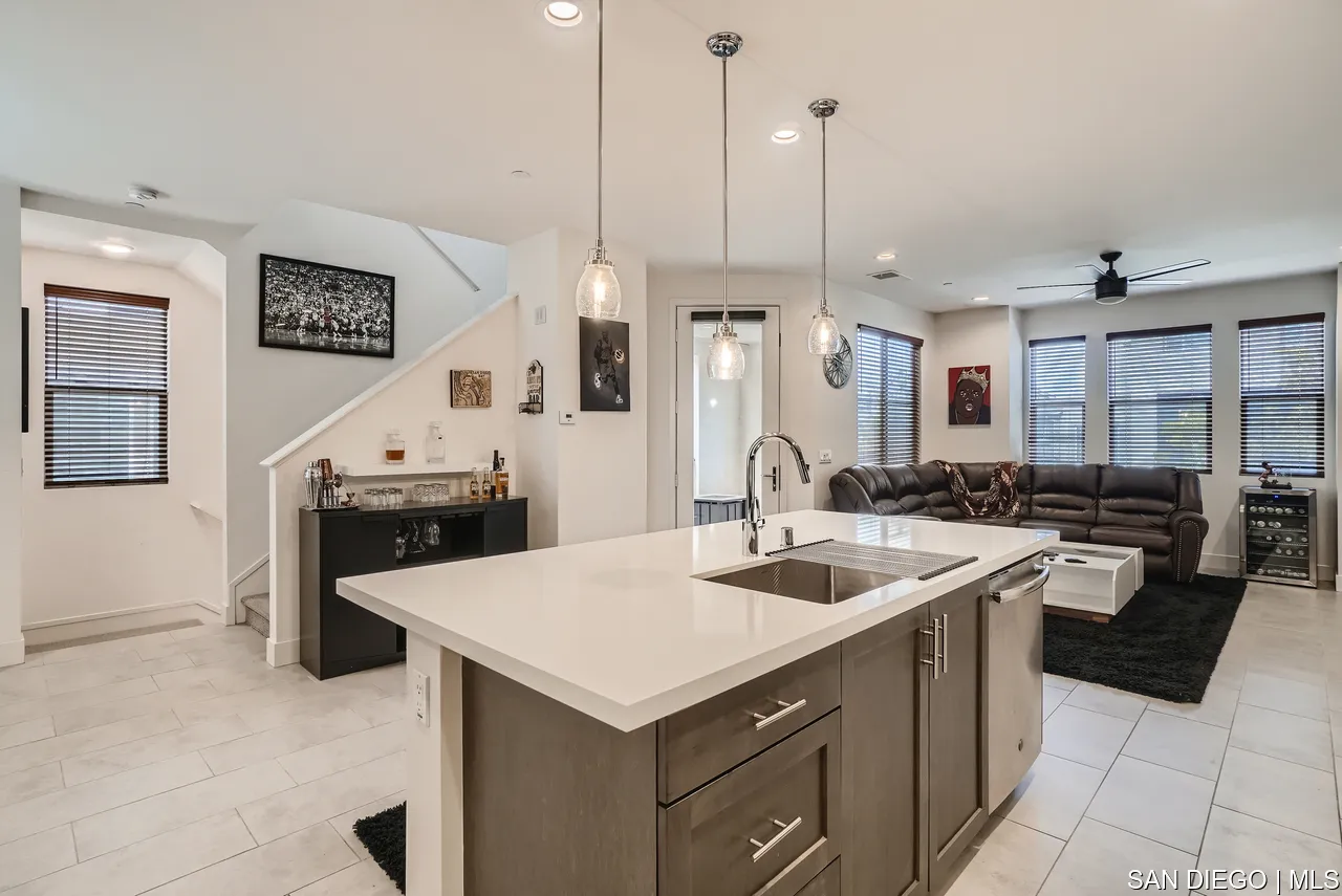 2110 Element Way Chula Vista, CA 91915 - Photo 13 of 33 a kitchen with a stove a sink a kitchen island with wooden cabinets and chairs