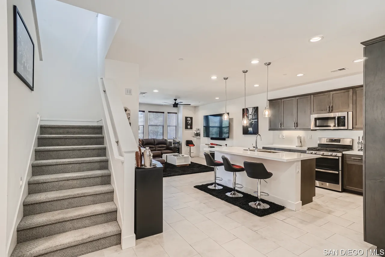 2110 Element Way Chula Vista, CA 91915 - Photo 10 of 33 a living room with furniture a flat screen tv and kitchen view