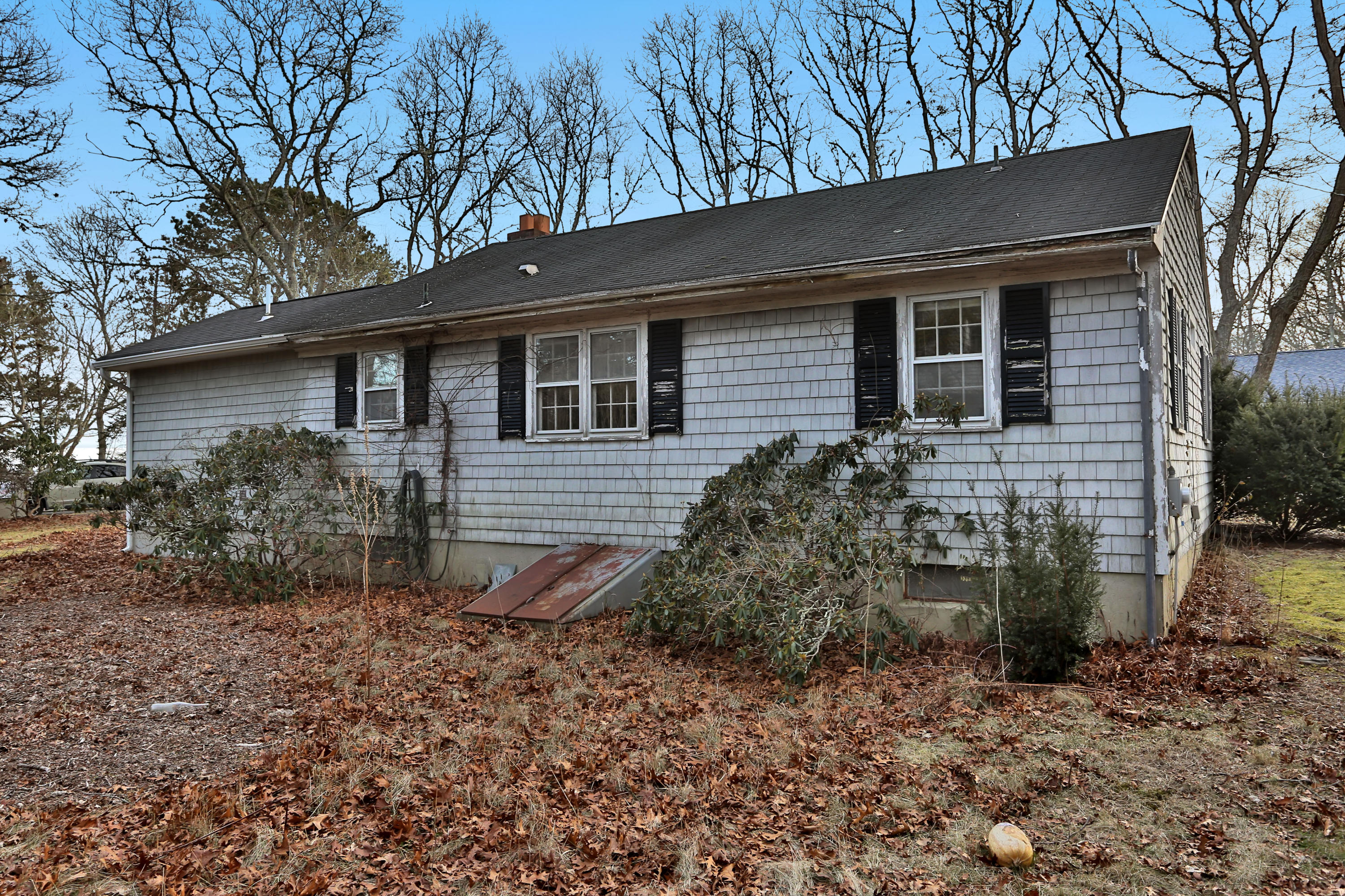 18 Menemsha Road Mashpee, MA 02649 - Photo 3 of 19 a backyard of a house with lots of green space