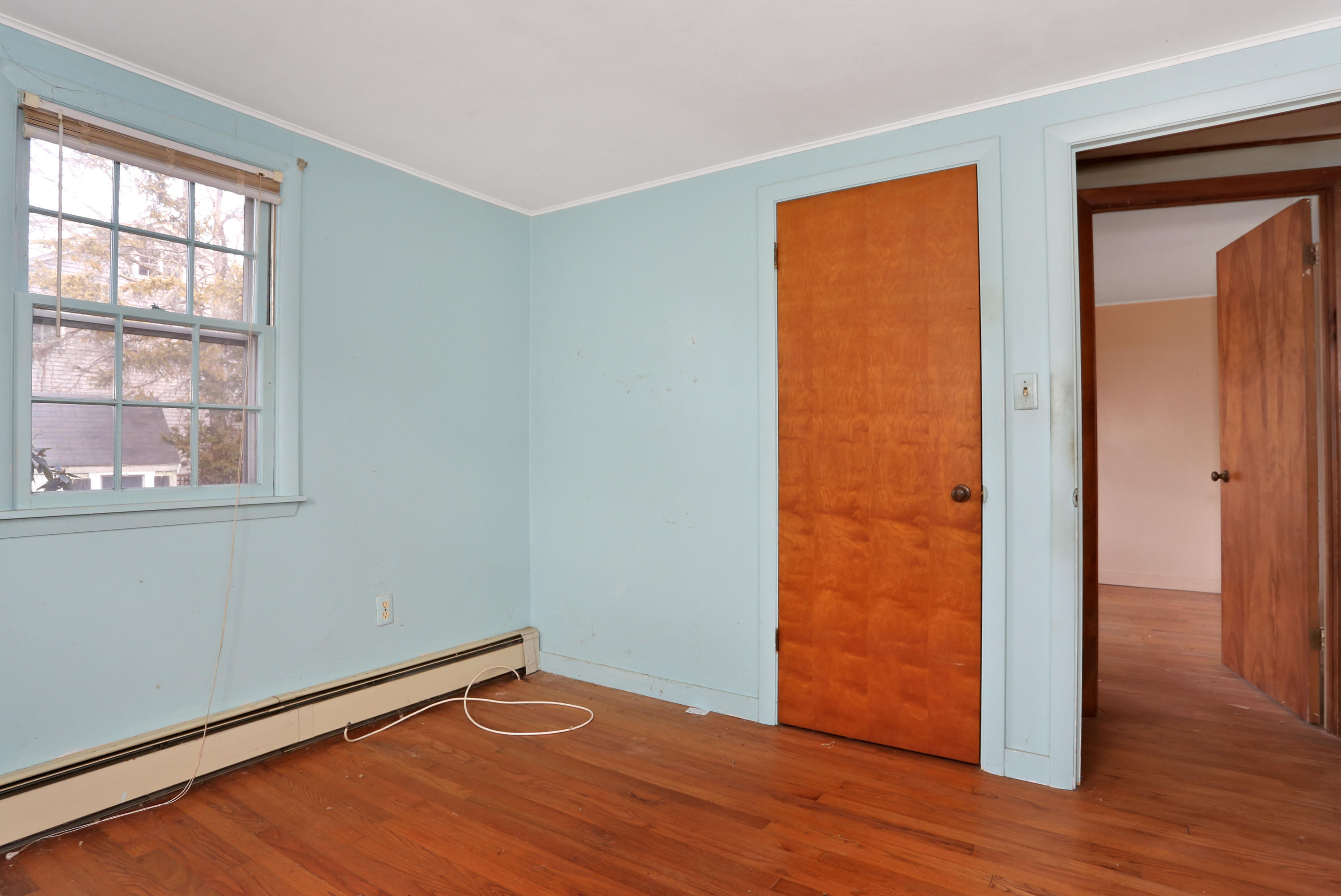 18 Menemsha Road Mashpee, MA 02649 - Photo 10 of 19 an empty room with wooden floor and a window