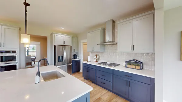 a kitchen with stainless steel appliances granite countertop a sink refrigerator and cabinets