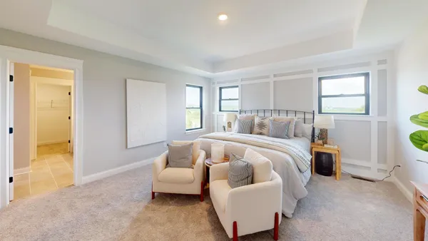a bedroom with bed and a couch