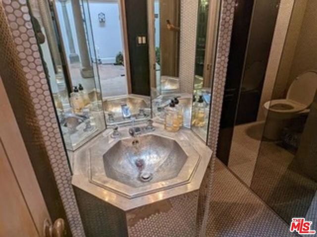 a kitchen with sink and refrigerator