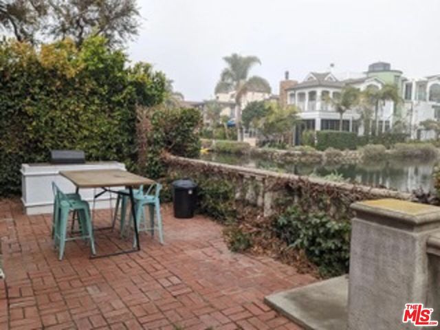 a view of a lake with a table and chairs