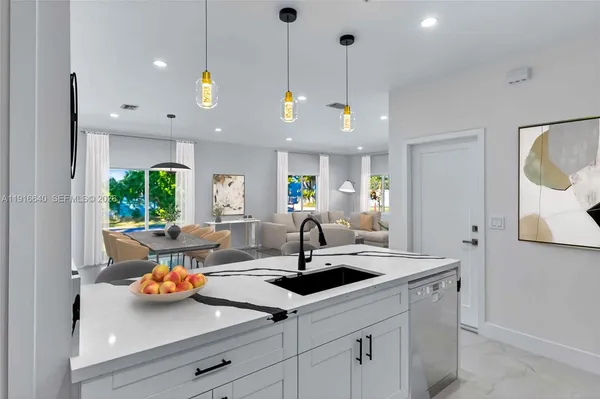 a kitchen with a sink and lots of wooden cabinets